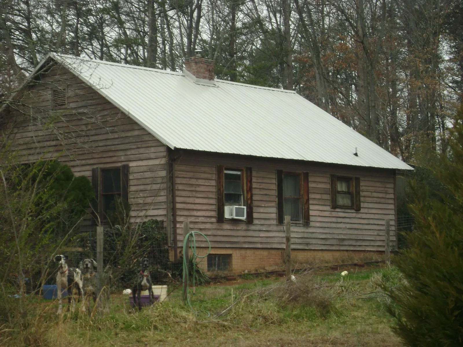 White metal roof on an old wood sided farmhouse, from a Metal Roof Installation job in Big Pool
